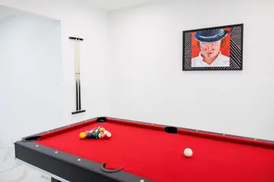a red pool table with a picture on the wall at Plumeria Housing in Fort Lauderdale