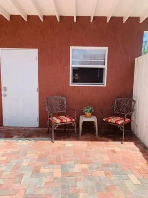 two chairs sitting in a room with a window at Coastal Cabana in Hollywood