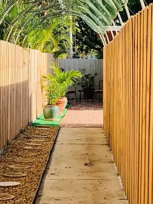 a garden with potted plants and a wooden fence at Coastal Cabana in Hollywood