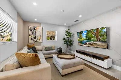 a living room with a couch and a tv at Spacious 4BR Waterfront Home with Private Pool, Tiki Hut & Free Parking near Miami & Key Largo in Cutler Bay