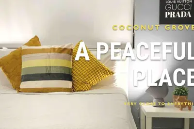 a bedroom with a bed with pillows on it at GroveO1 10 min from the beach in Miami