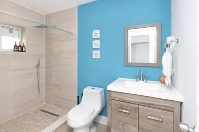 a bathroom with a toilet and a sink and a mirror at Casa Bora Bora - Fun in Miami - Big Pool - Fit 12 in Miami