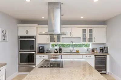 a kitchen with white cabinets and a stainless steel appliances at Casa Bora Bora - Fun in Miami - Big Pool - Fit 12 in Miami