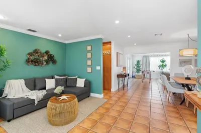 a living room with a gray couch and a blue wall at Casa Cabos - Fun in Miami - Pool BBQ - Fit 10 in Tamiami