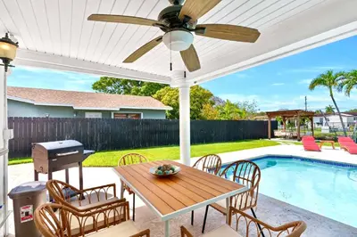 a patio with a table and chairs and a pool at Casa Cabos - Fun in Miami - Pool BBQ - Fit 10 in Tamiami
