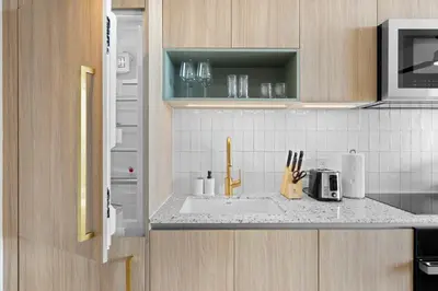 a kitchen counter with a sink and a microwave at On 47th Floor! Apartment With Top Amenities in Miami