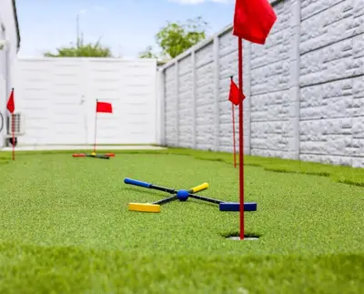 a group of golf balls and red flags on the grass at Gables Paradise - Htd Pool,5 Bdrooms ,Mini Golf, Playground, Baby Items, BBQ in Tamiami