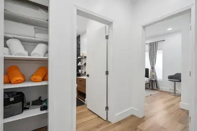 a walk in closet with white cabinets and shelves at Casa Roselle On The Beach Full 22 in Hollywood