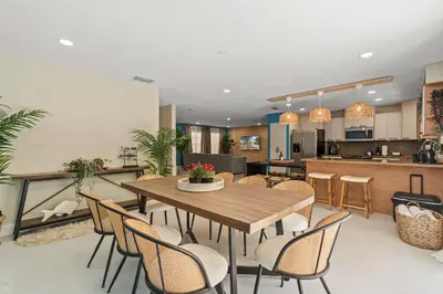 a dining room and kitchen with a table and chairs at Casa Maldivas - Blue Oasis - Heated Pool in Tamiami