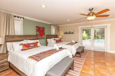 a bedroom with two beds and a ceiling fan at Casa Mexican home - Big Pool - Hot Tub - FITS 12 in Miami