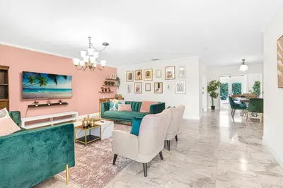 a living room with a green couch and chairs at Casa Praga - Big pool & BBQ - Miami Fun in Tamiami
