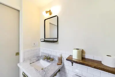a bathroom with a sink and a mirror at Jefferson Hotel in Miami
