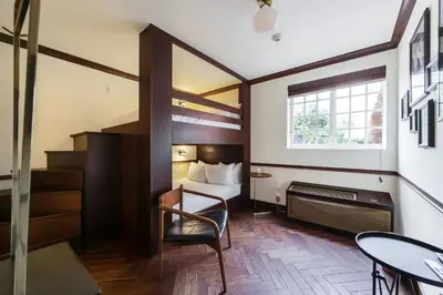 a hotel room with a bed and a table and chair at Jefferson Hotel in Miami
