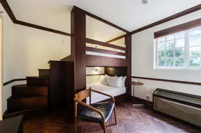 a hotel room with a bed and a staircase at Jefferson Hotel in Miami