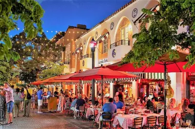 a group of people sitting at tables outside a building at TROPICAL HAVEN POOL & 2BLOCKS TO BEACh in Miami Beach