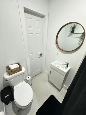 a bathroom with a white toilet and a mirror at Stay Where Miami Comes Alive in Miami