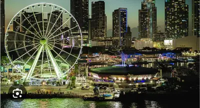 a ferris wheel in front of a city at night at Stay Where Miami Comes Alive in Miami