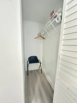 a hallway with a chair in a white room at 5 Star Feel in Miami Prime Location in Miami