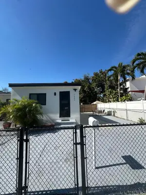 a white house behind a chain link fence at 5 Star Feel in Miami Prime Location in Miami