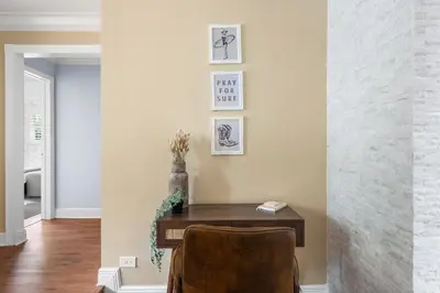 a home office with a wooden desk and pictures on the wall at Centrally Located 4BD Oasis with Pool & Movie Patio in Hollywood