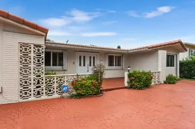 a house with a red brick driveway in front of it at Centrally Located 4BD Oasis with Pool & Movie Patio in Hollywood