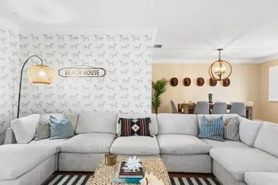 a living room with a couch and a table at Centrally Located 4BD Oasis with Pool & Movie Patio in Hollywood