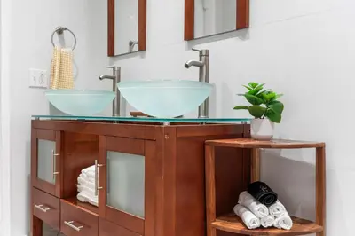 a bathroom with a sink and two mirrors at Centrally Located 4BD Oasis with Pool & Movie Patio in Hollywood