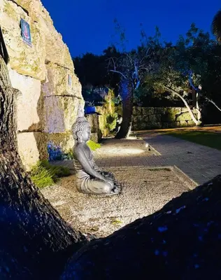 a statue of a mermaid sitting on the ground at Lake Of Dreams Miami House in Miami