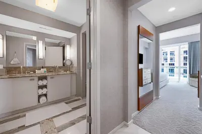 a bathroom with a sink and a mirror at Beachfront Condo Fort Lauderdale in Fort Lauderdale