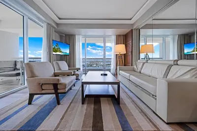 a living room with a couch and a chair and a table at Beachfront Condo Fort Lauderdale in Fort Lauderdale