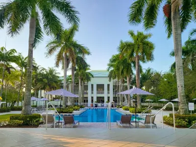 a resort with a pool and palm trees at Doral Pool 1407 by WaveProperties in Miami