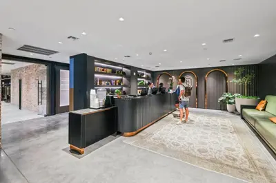 a man standing at a bar in a hotel lobby at Resort-Style Living 1BR Apt in Downtown Miami in Miami