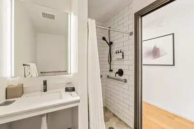 a white bathroom with a sink and a shower at Resort-Style Living 1BR Apt in Downtown Miami in Miami