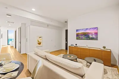 a living room with white furniture and a painting on the wall at Resort-Style Living 1BR Apt in Downtown Miami in Miami