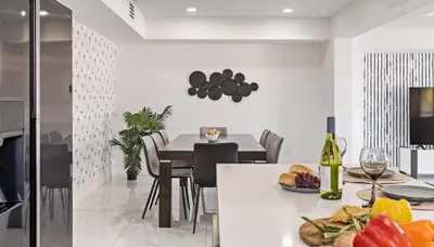 a kitchen and dining room with a table with a plate of food at April Sale! 4BR - Private Yard, Grill, Soaking Tub, Near Coral Gables & MIA Airport in Tamiami
