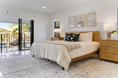 a bedroom with a large bed and a balcony at April Sale! 4BR - Private Yard, Grill, Soaking Tub, Near Coral Gables & MIA Airport in Tamiami
