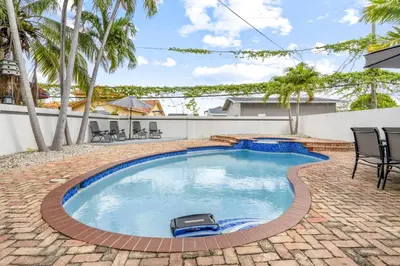 a swimming pool in a yard with chairs and trees at April Sale! 4 BR - Private Pool, Grill, Soaking Tub, Near Coral Gables & MIA Airport in Miami