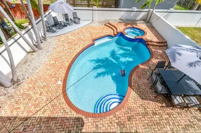 an overhead view of a swimming pool on top of a house at April Sale! 4 BR - Private Pool, Grill, Soaking Tub, Near Coral Gables & MIA Airport in Miami