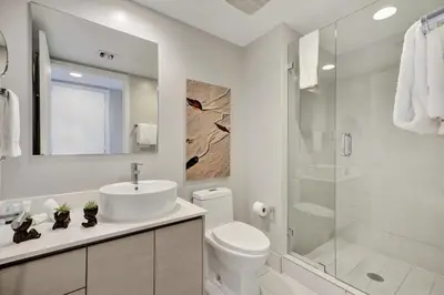 a bathroom with a sink and a toilet and a shower at Beachwalk Resort in Hallandale Beach