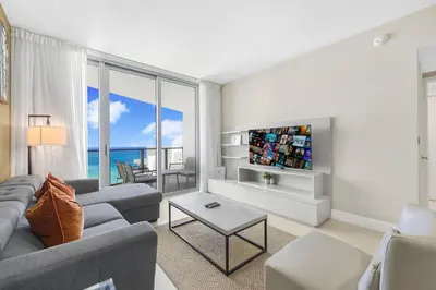 a living room with a couch and a table at Amazing Oceanfront Views From 24th floor! in Hollywood