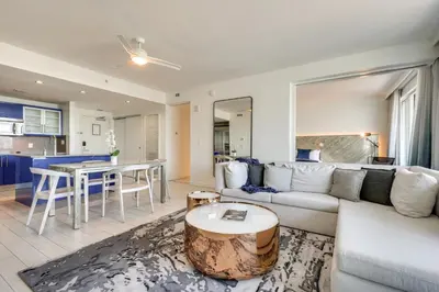 a living room with a couch and a table at Walk to Beach and Dining! Luxe Fort Lauderdale Condo in Fort Lauderdale