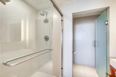 a shower with a glass door in a bathroom at Walk to Bars and Eats! Luxe Ft Lauderdale Condo in Fort Lauderdale