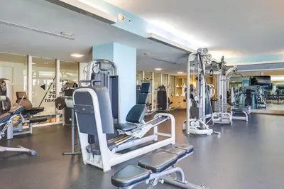 a gym with several tread machines in a room at Walk to Bars and Eats! Luxe Ft Lauderdale Condo in Fort Lauderdale