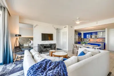 a living room with a white couch and a table at Walk to Bars and Eats! Luxe Ft Lauderdale Condo in Fort Lauderdale