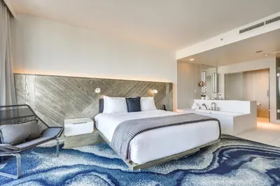 a bedroom with a large bed and a bathroom at Walk to Bars and Eats! Luxe Ft Lauderdale Condo in Fort Lauderdale