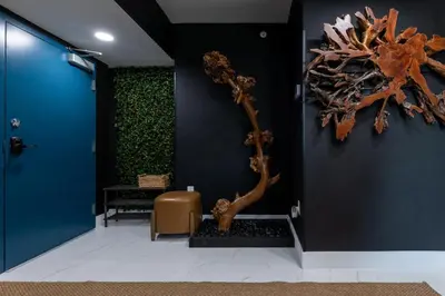 a lobby with a blue wall with a sculpture on it at MONROE APART HOTEl in Hollywood