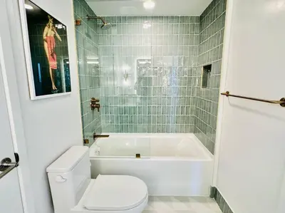 a bathroom with a tub and a toilet and a sink at 43 Floor Miami 1BD Near Arena in Miami