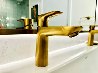 a gold faucet on a sink in a bathroom at 43 Floor Miami 1BD Near Arena in Miami