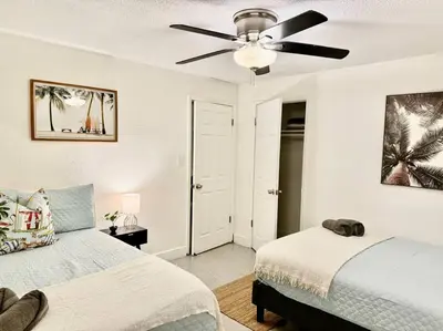 a bedroom with two beds and a ceiling fan at New Brisa Marina in Fort Lauderdale