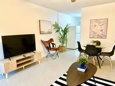 a living room with a flat screen tv and chairs at New Brisa Marina in Fort Lauderdale